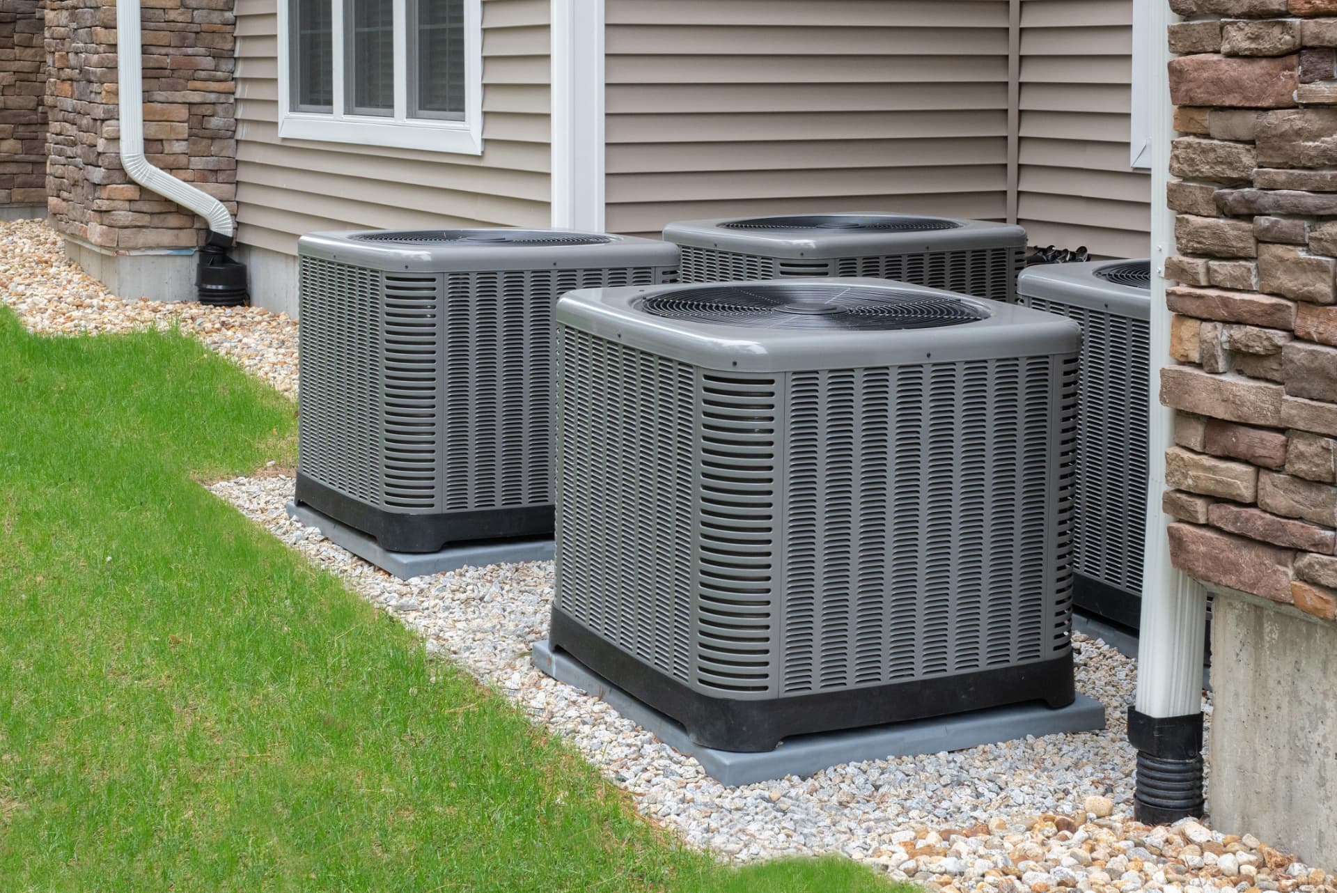 Row of outdoor heat pump units at a property